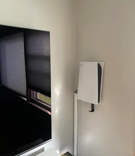 Gaming console mounted near a TV