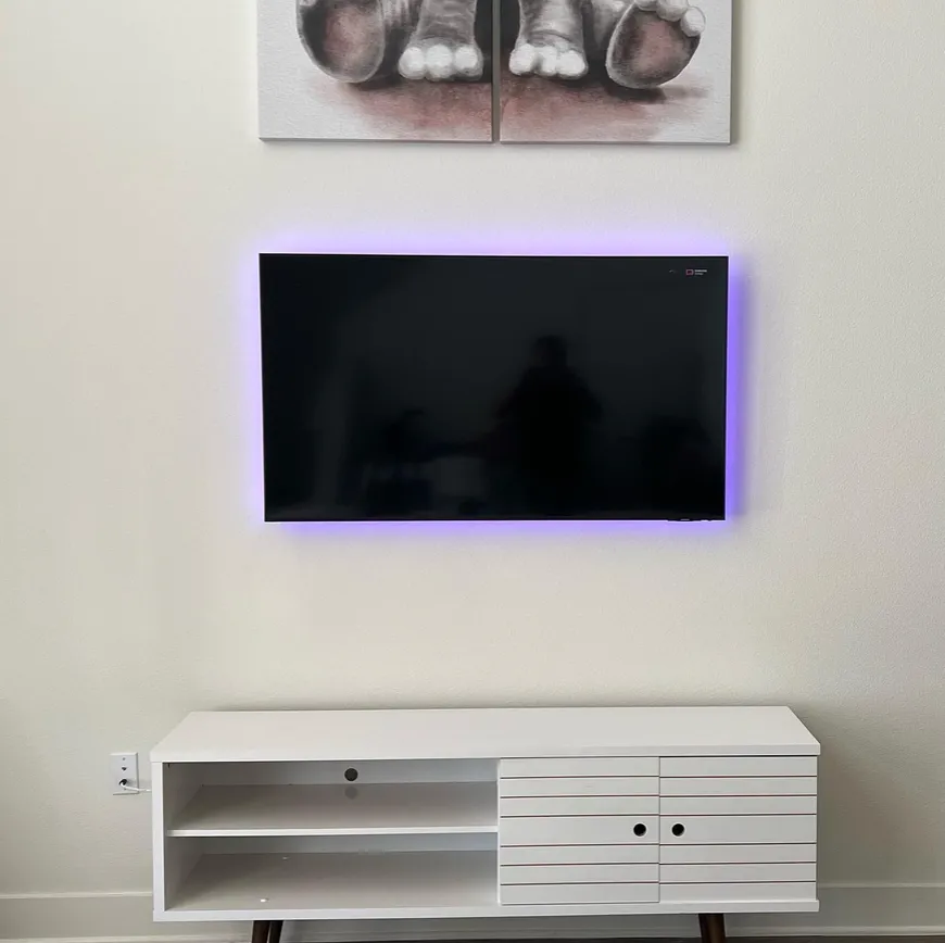 In-wall cable routing behind a wall-mounted TV