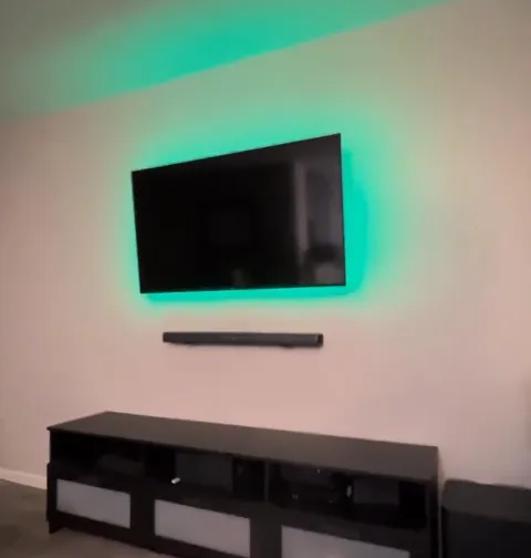 Soundbar centered under a wall-mounted TV