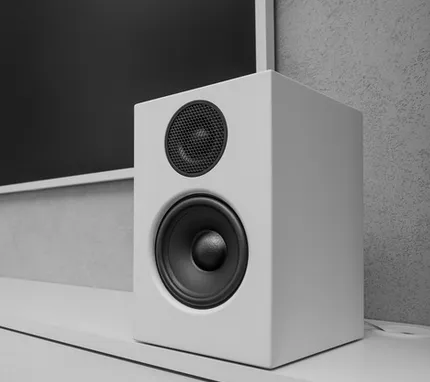 Wall-mounted surround sound speakers in a media room
