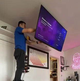 Ceiling TV mount in a modern bedroom