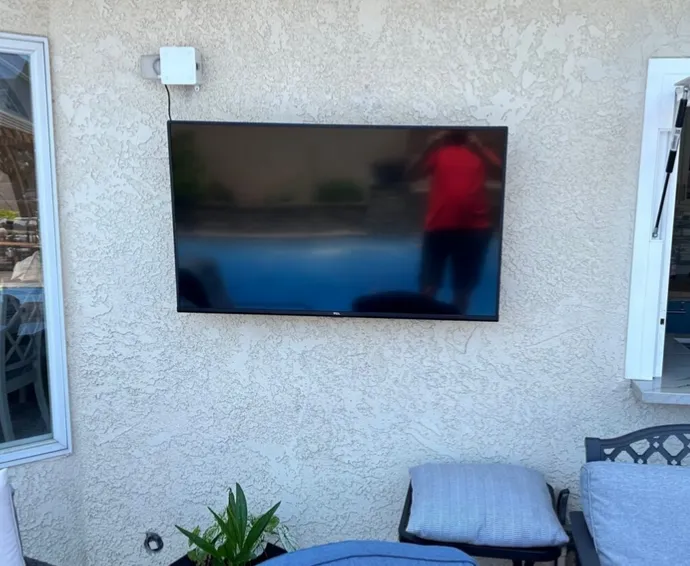 Outdoor TV mounted on a covered patio
